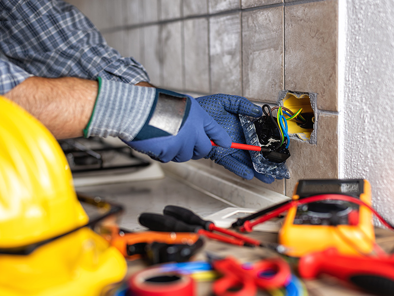 electrician-close-up-repairing-wall-outlet-at-kitchen-arnold-md Residential Electrician in Annapolis, MD